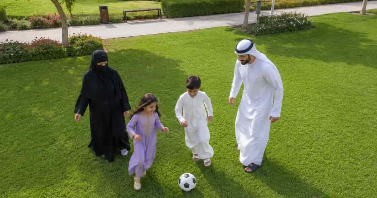 Family is playing with their childrens in the park