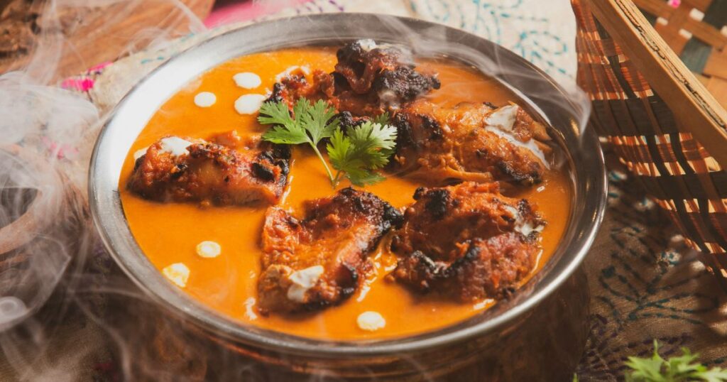 Steaming curry served in a traditional metal bowl