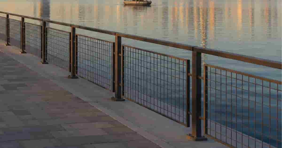 Wide waterfront, calm water, city skyline near park