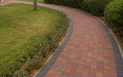 **Alt text:** Curved brick walkway surrounded by rounded green hedges and trees in a Al Mankhool park.
