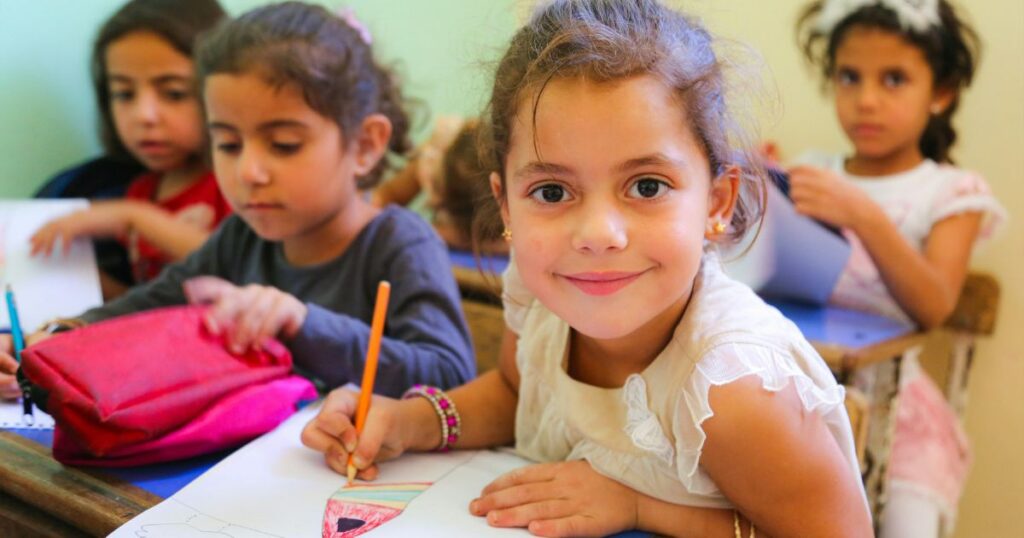 Children are sitting in a school class